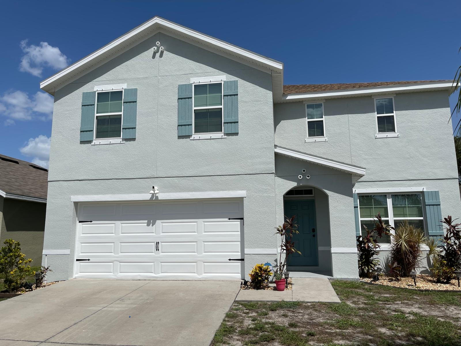 Two-story home after exterior paint work