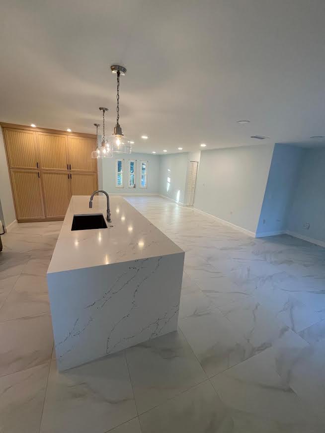 Kitchen remodel with marble-look flooring and island