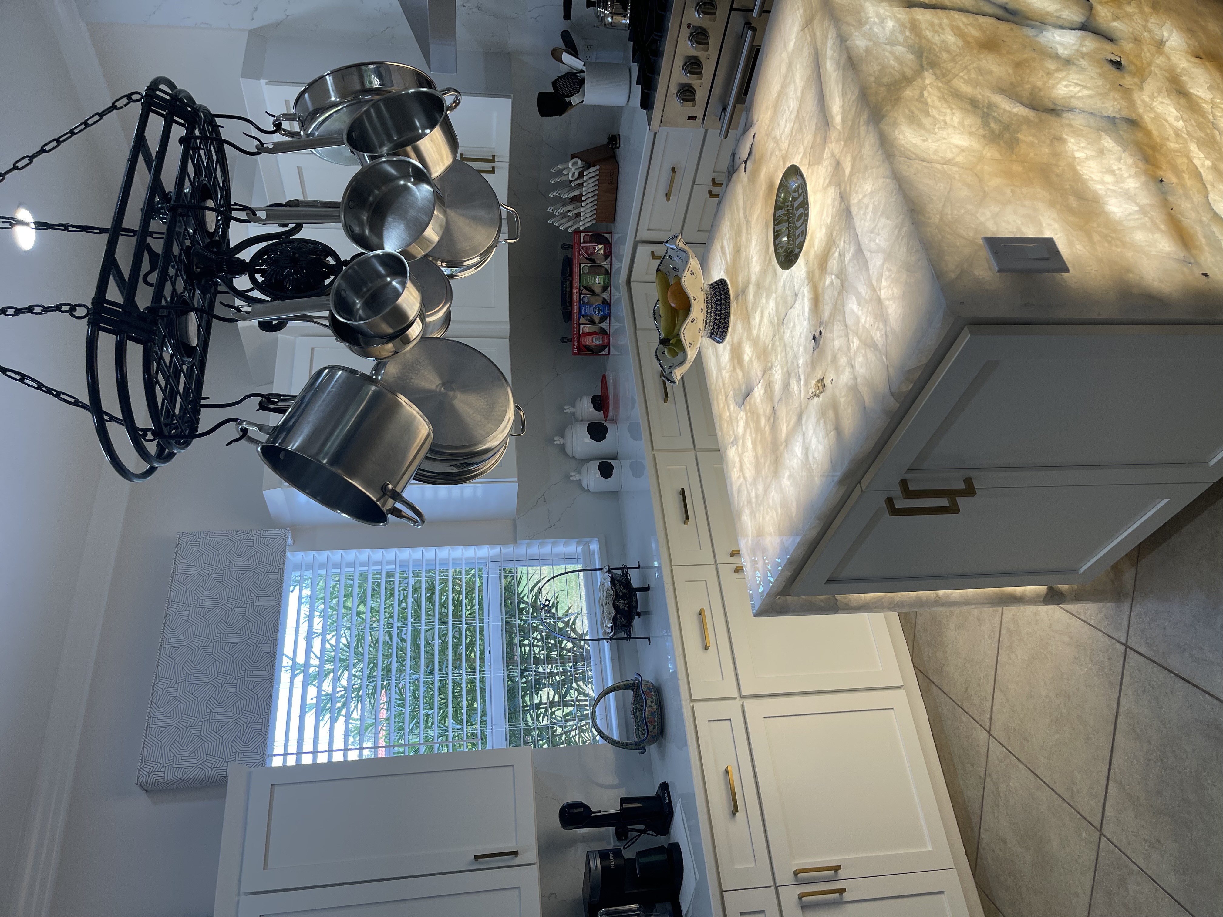 Kitchen remodel with light cabinetry, large island, and updated flooring