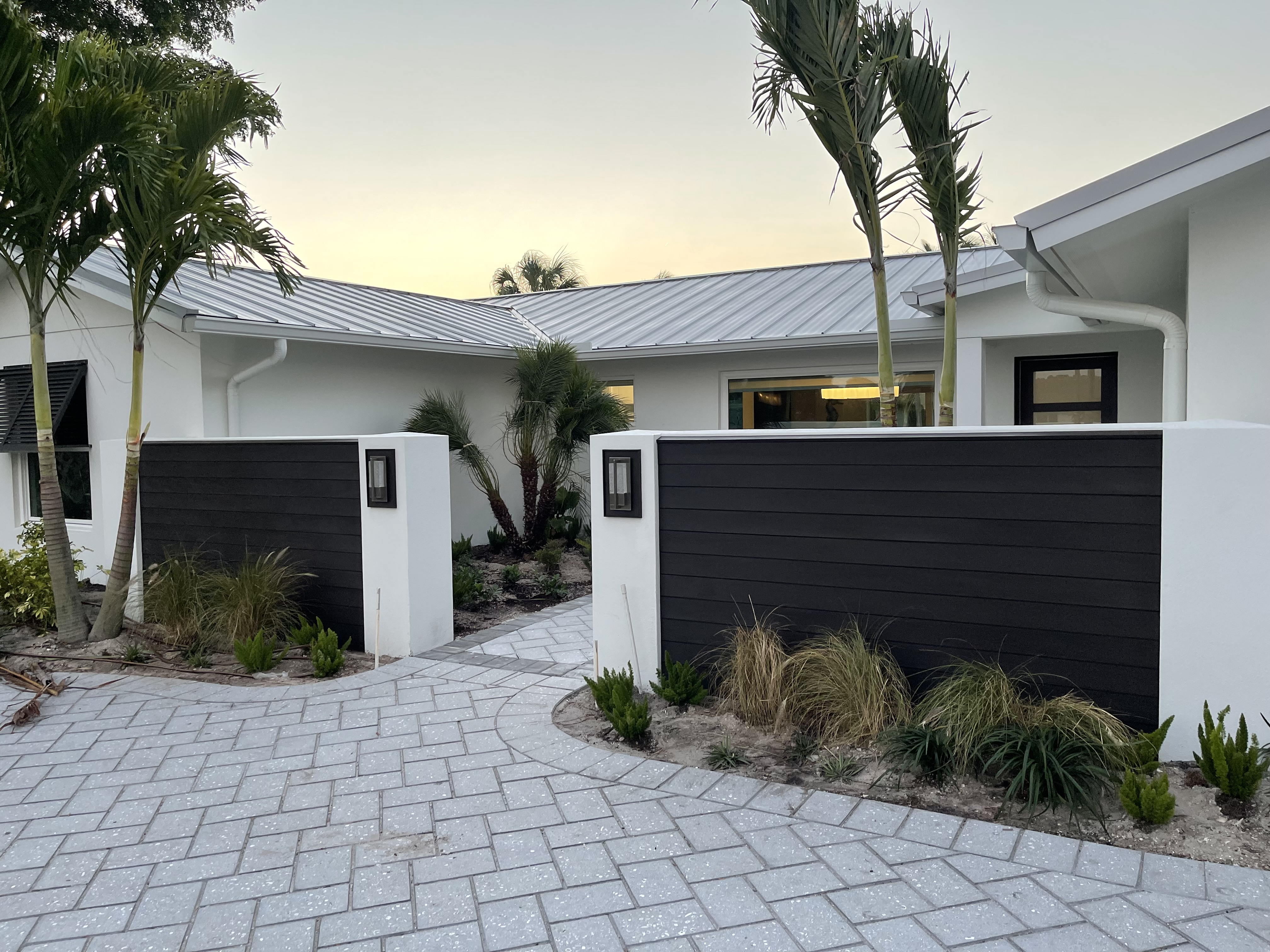 Modern home exterior with black stained wood panels by RDS Home Solutions